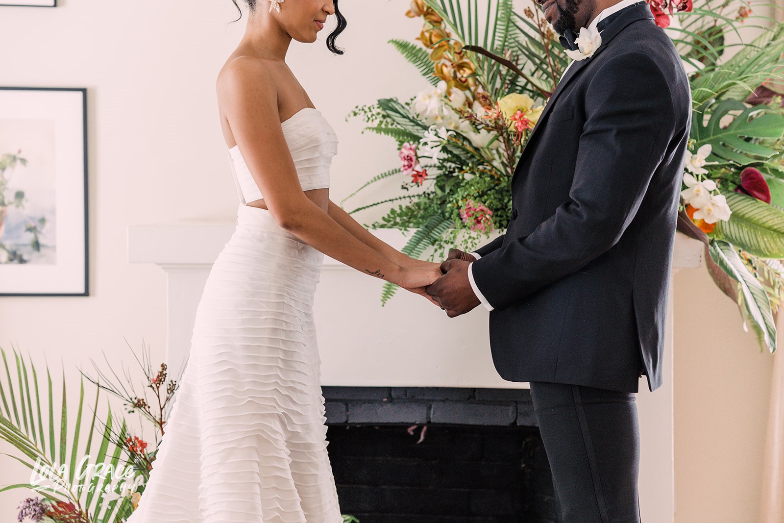 a couple holds hands at the altar