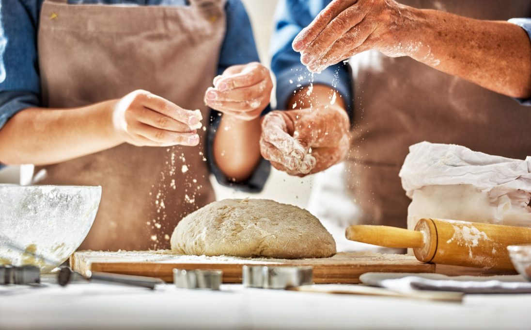 a woman and a man making pasta dough