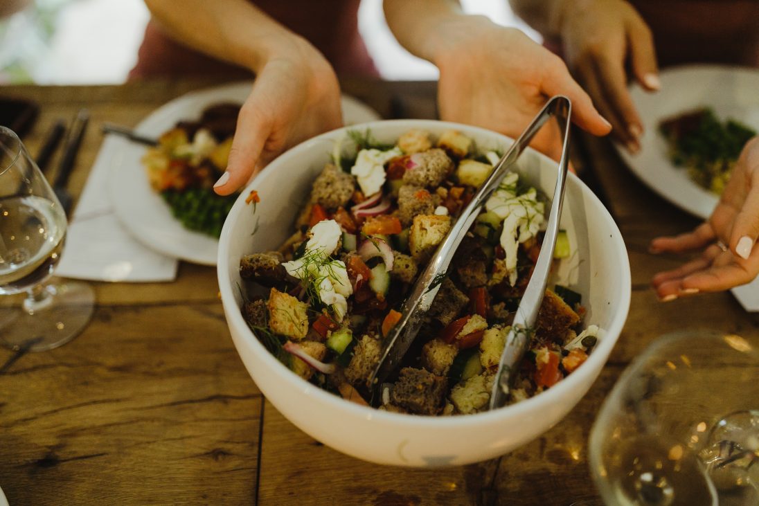 white bowl of salad with hunks of tomatoes, bread and mozarella cheese